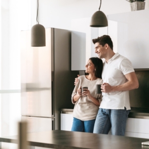 Happy couple enjoying their coffee in the kitchen